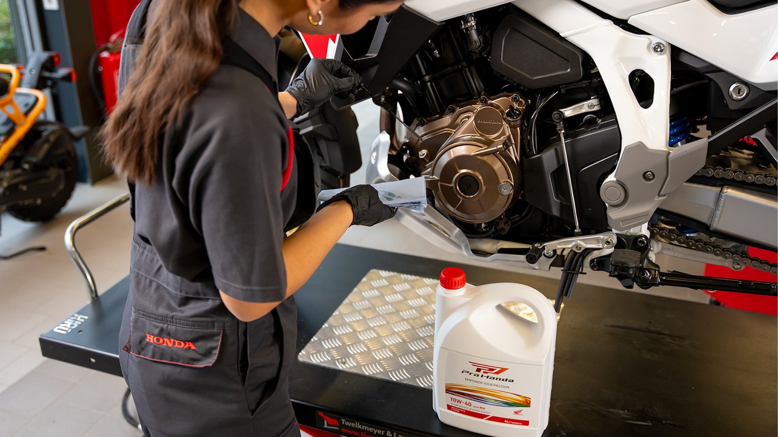 A view of a mechanic working on a Honda bike.