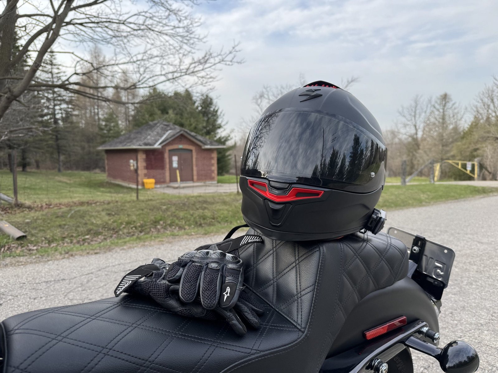 Scorpion EXO-Eclipse Solid Helmet resting on a Harley Davidson seat