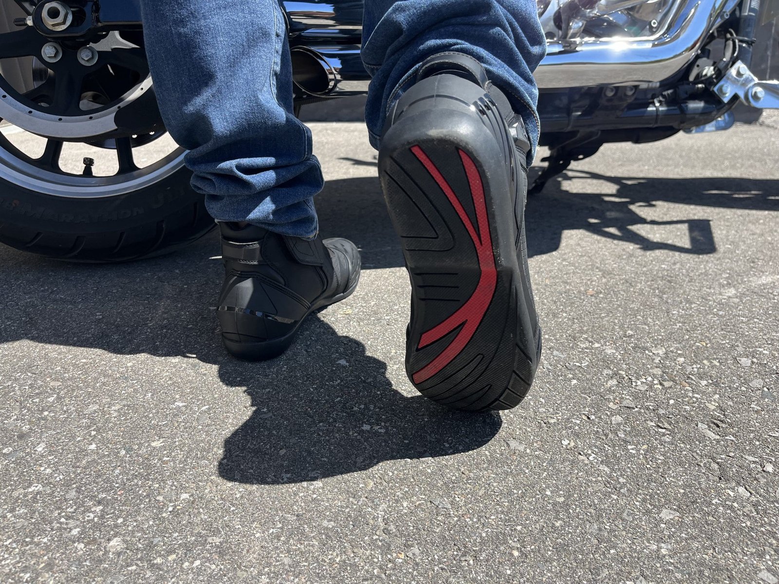 motorcycle rider walking in Cortech Sport Lite Boots towards harley sportster