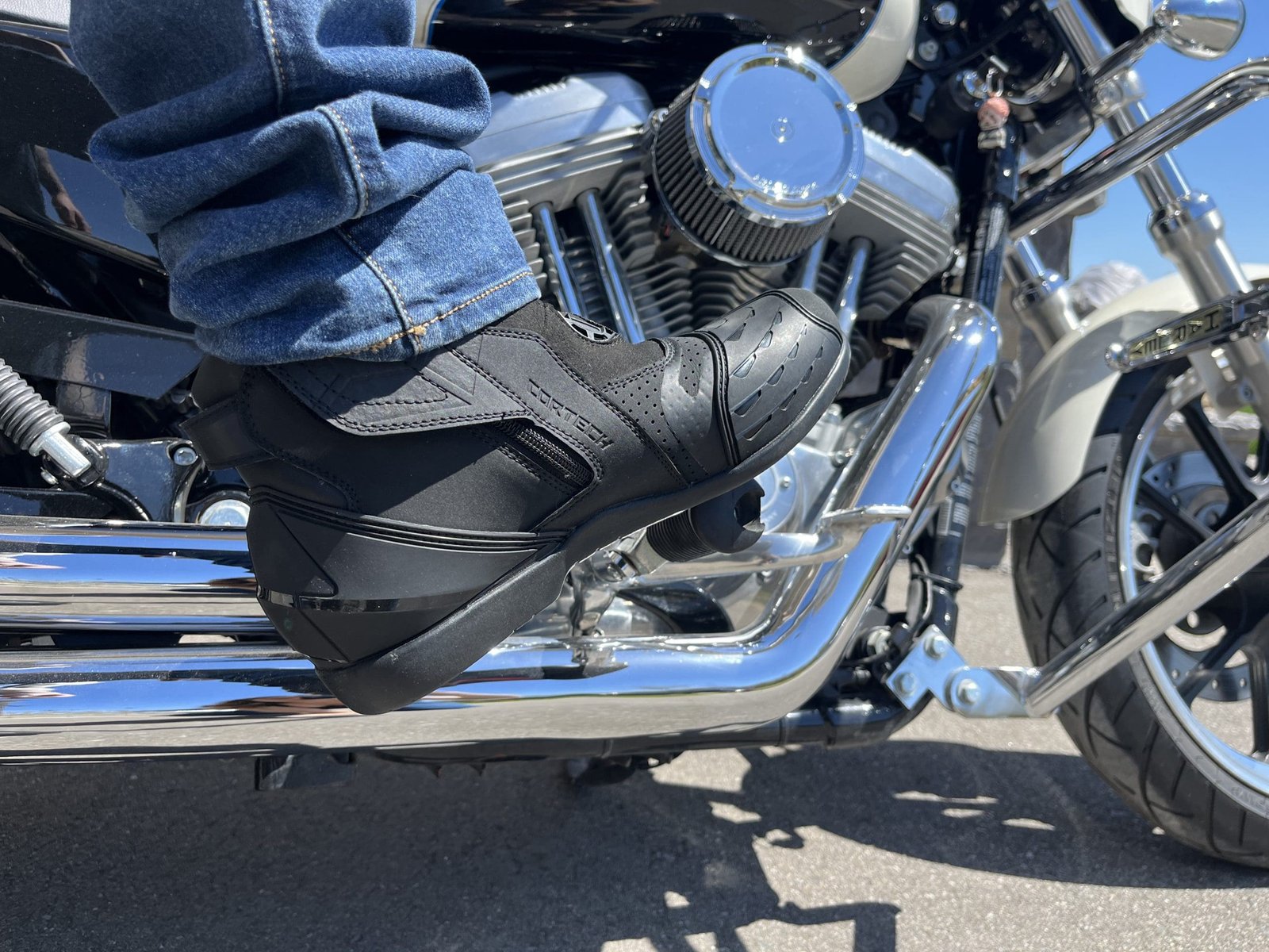 Cortech Sport Lite Boot resting on foot peg of harley davidson.