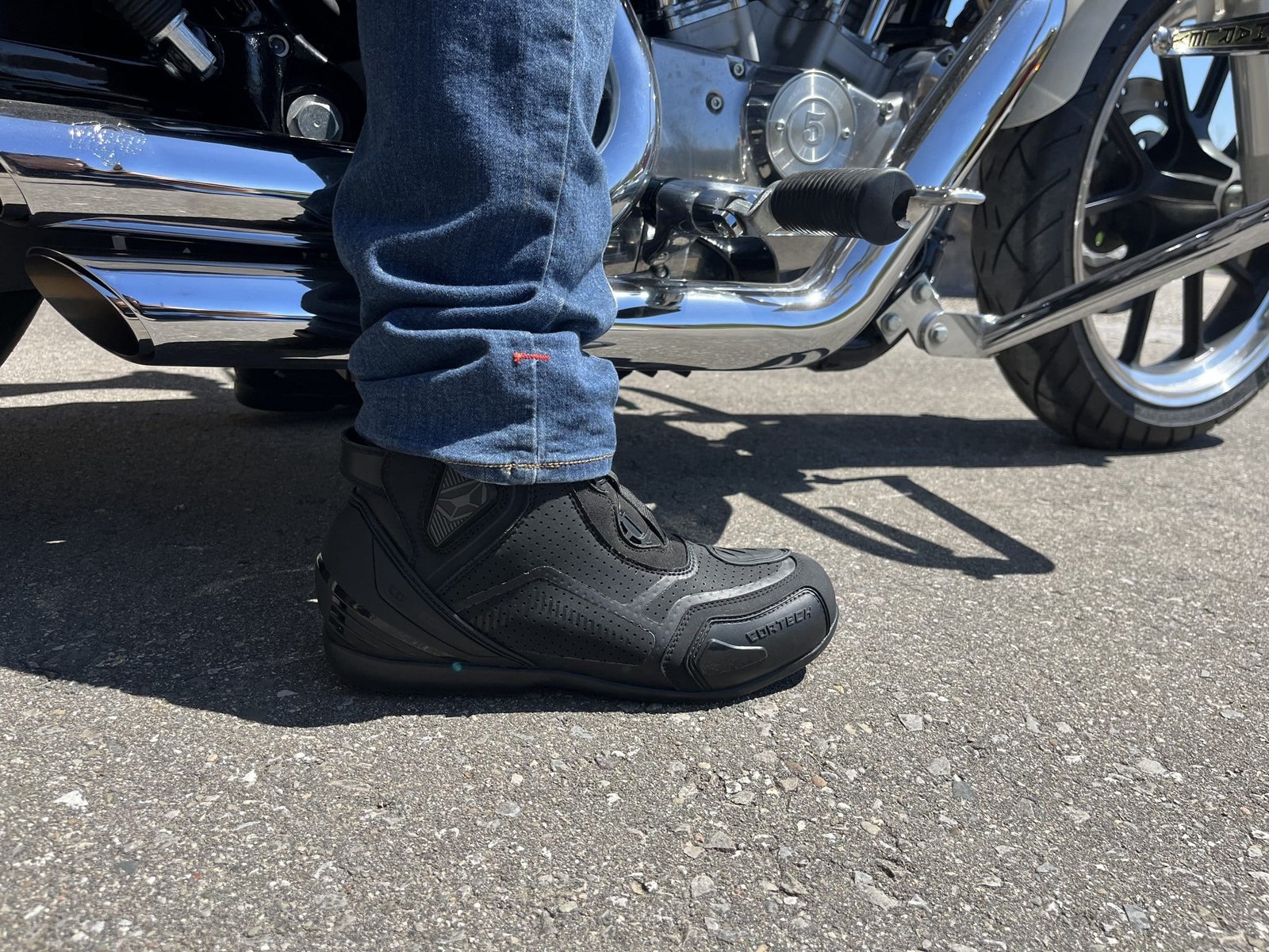 Cortech Sport Lite Boots planted on the ground while rider sits on harley davidson sportster.