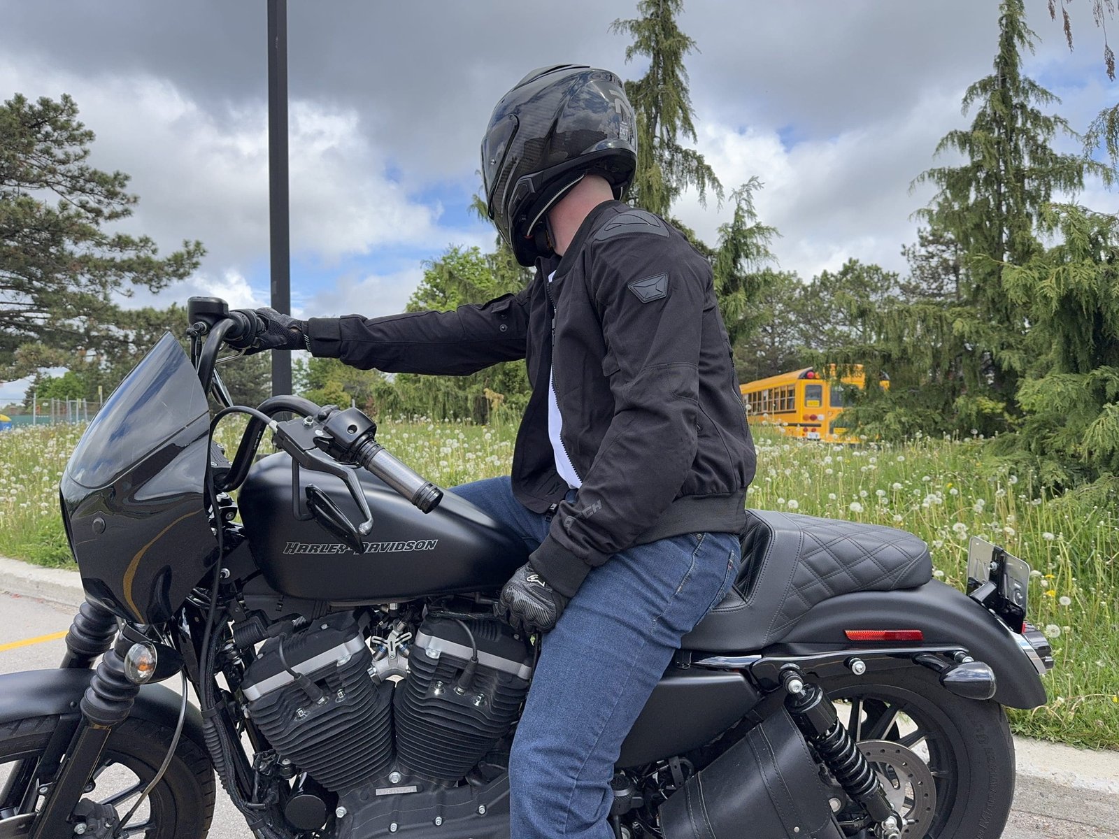 Side view of a rider wearing the Cortech Versa-Flo Jacket on a Harley Davidson