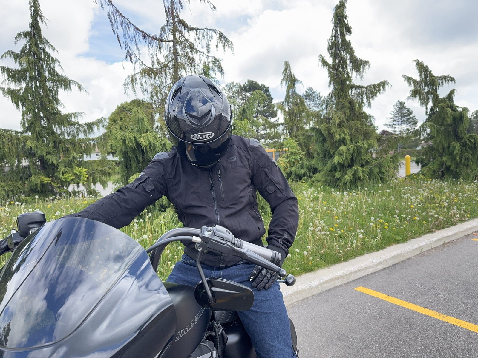 Rider wearing the HJC RPHA 71 Carbon Helmet looking down