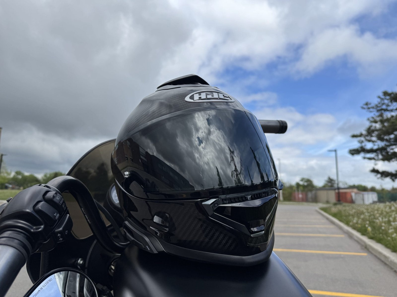 HJC RPHA 71 Carbon resting on a Harley Davidson gas tank