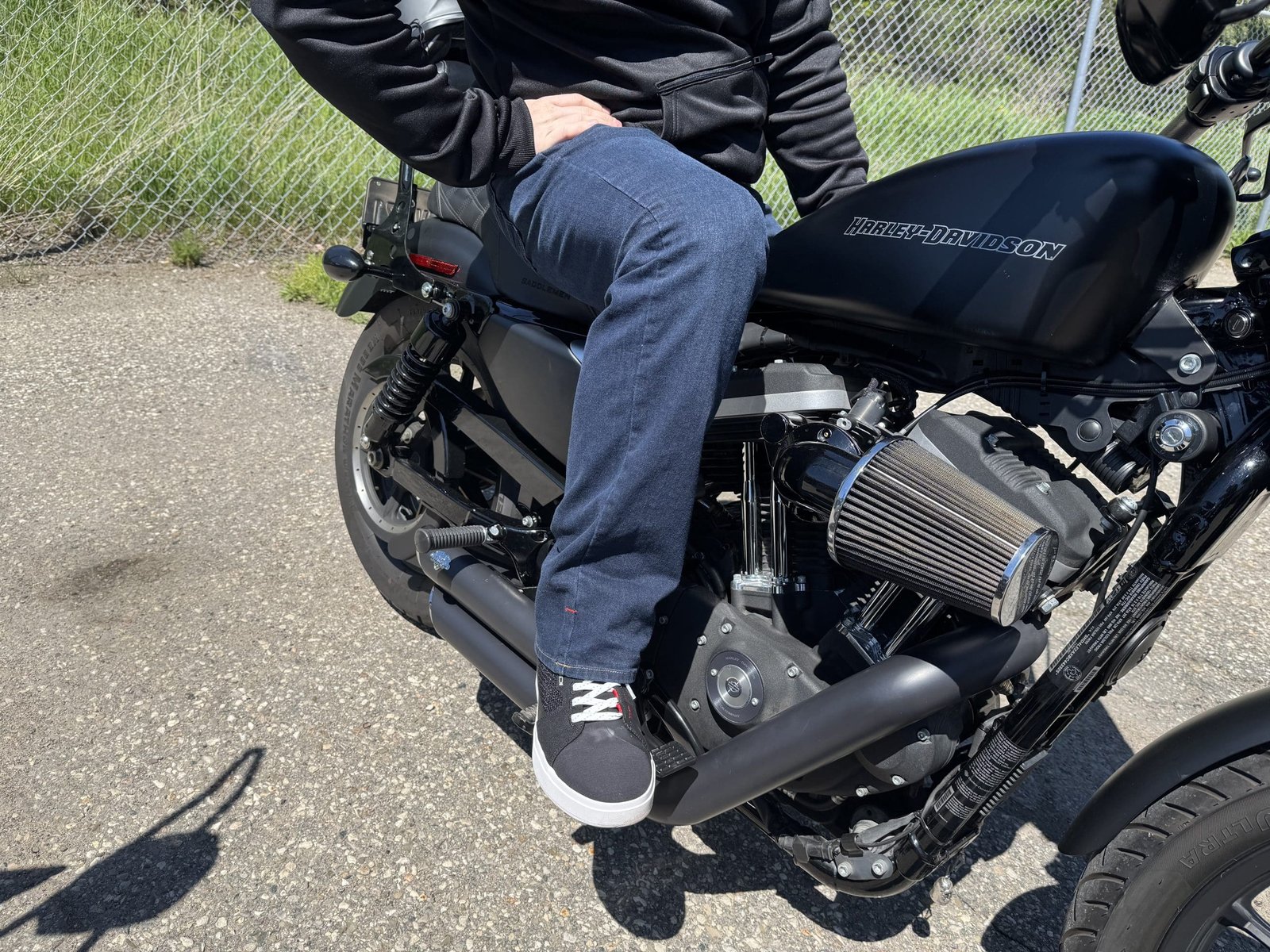 Rider sitting on a Harley Davidson wearing the Klim K Forty 2 Stretch Denim Jeans