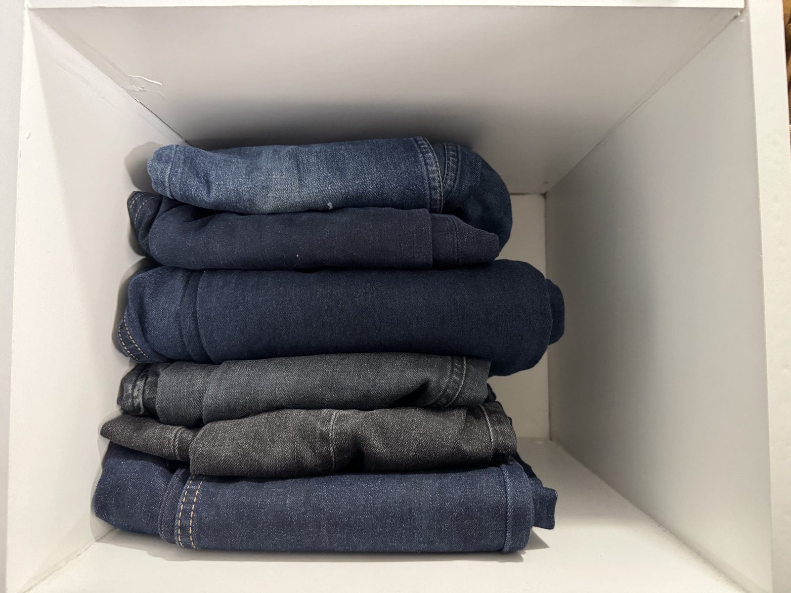 Jeans folded in a closet