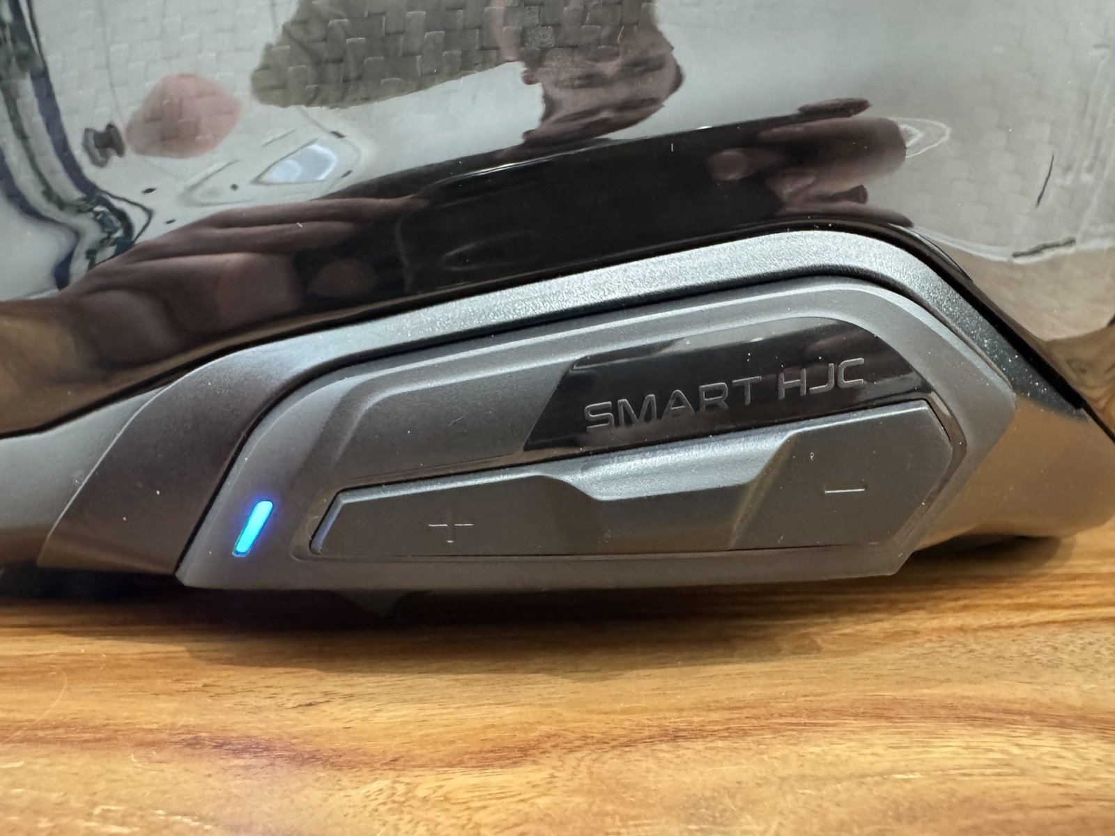 Sena SMART HJC 50B Installed on a helmet with the light indicating the unit is on