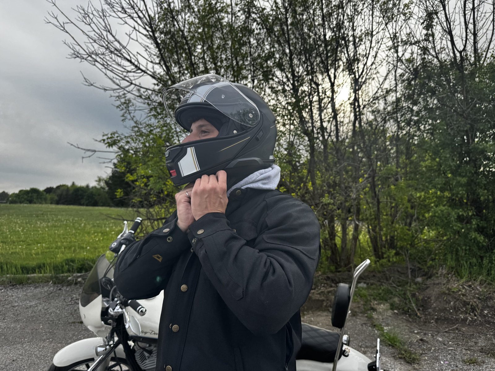 motorcycle rider putting on Shoei Neotec 3 Satori TC-5 Helmet