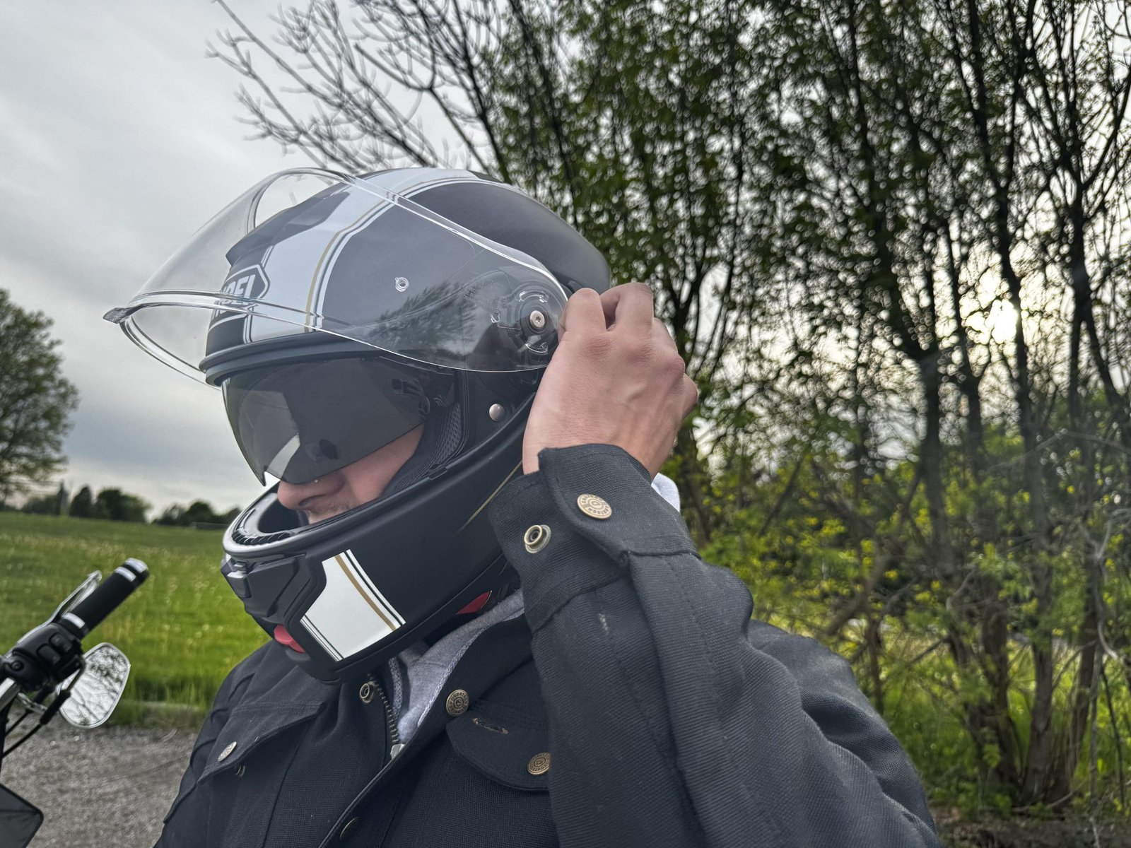 motorcycle rider using the QSV-2 internal sun visor inside of the Shoei Neotec 3 Satori TC-5 Helmet