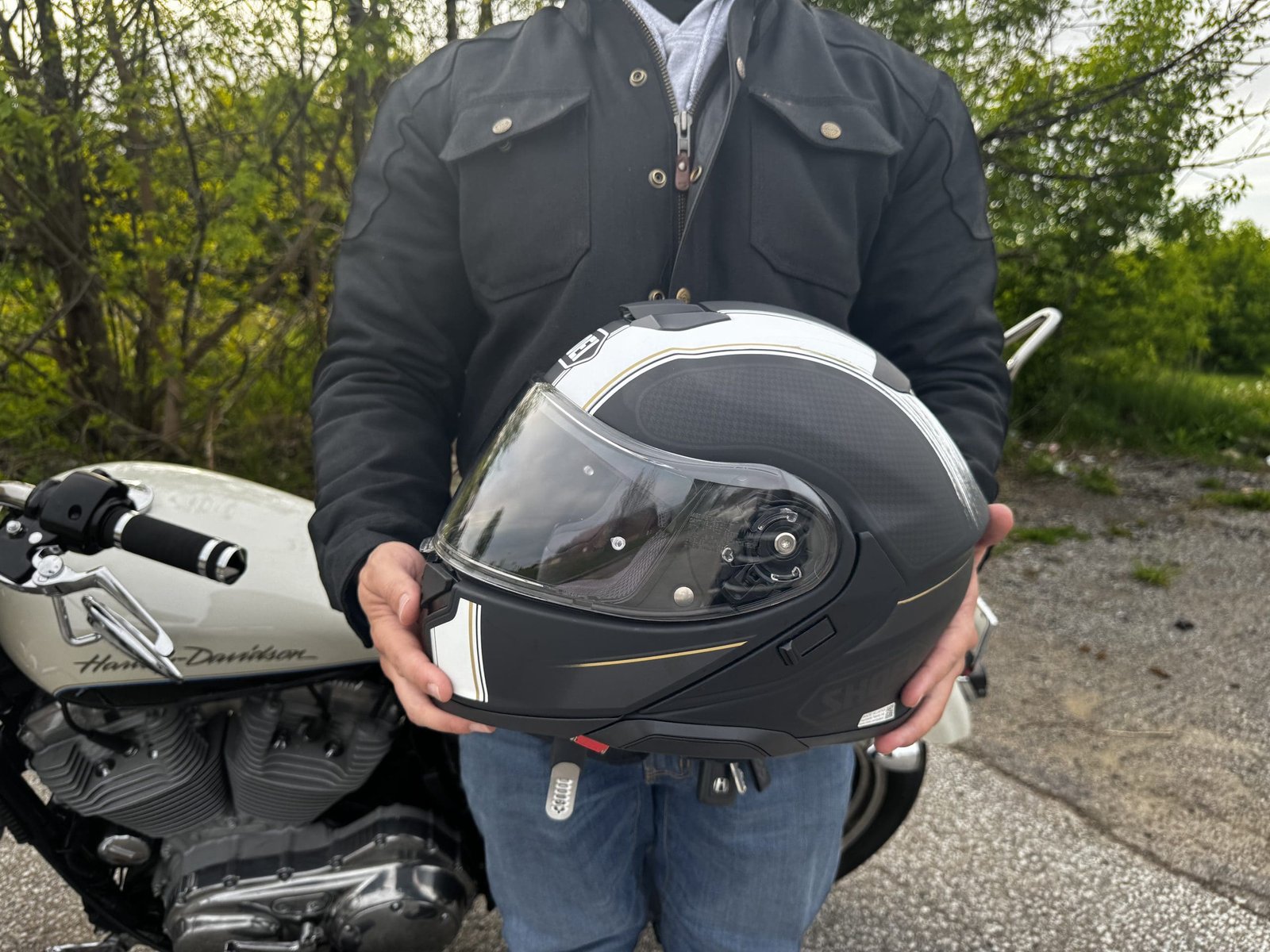 motorcycle rider holding the Shoei Neotec 3 Satori TC-5 Helmet
