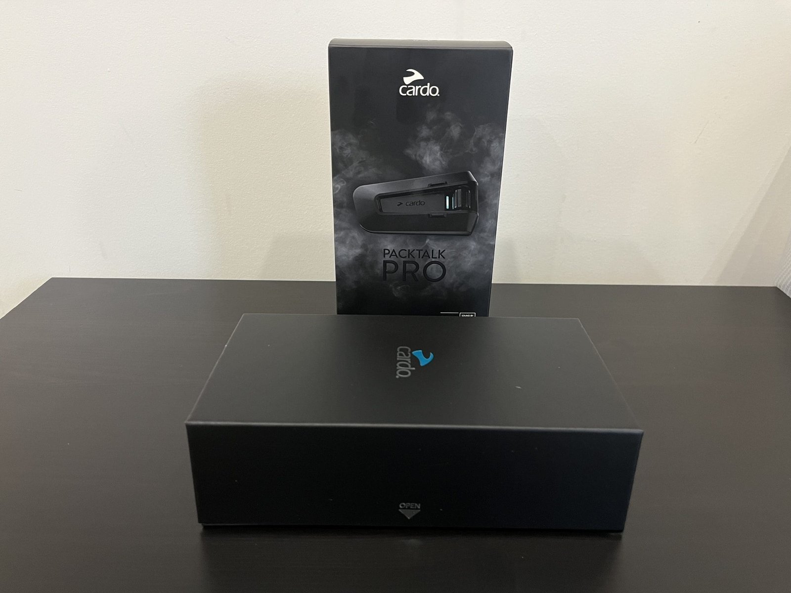 Cardo Packtalk Pro box on table