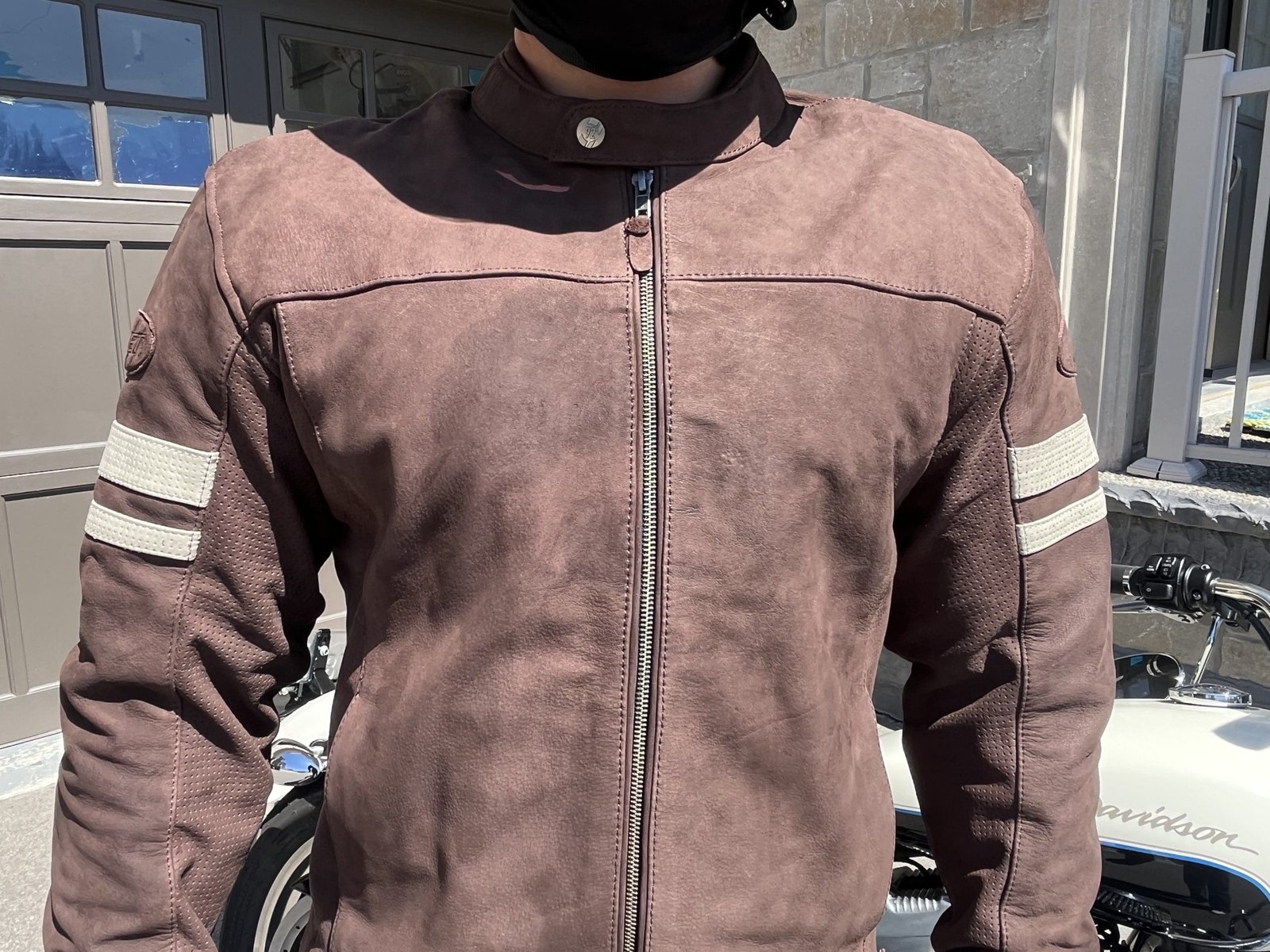 motorcycle rider wearing Joe Rocket Classic 92 Leather Jacket with harley in background