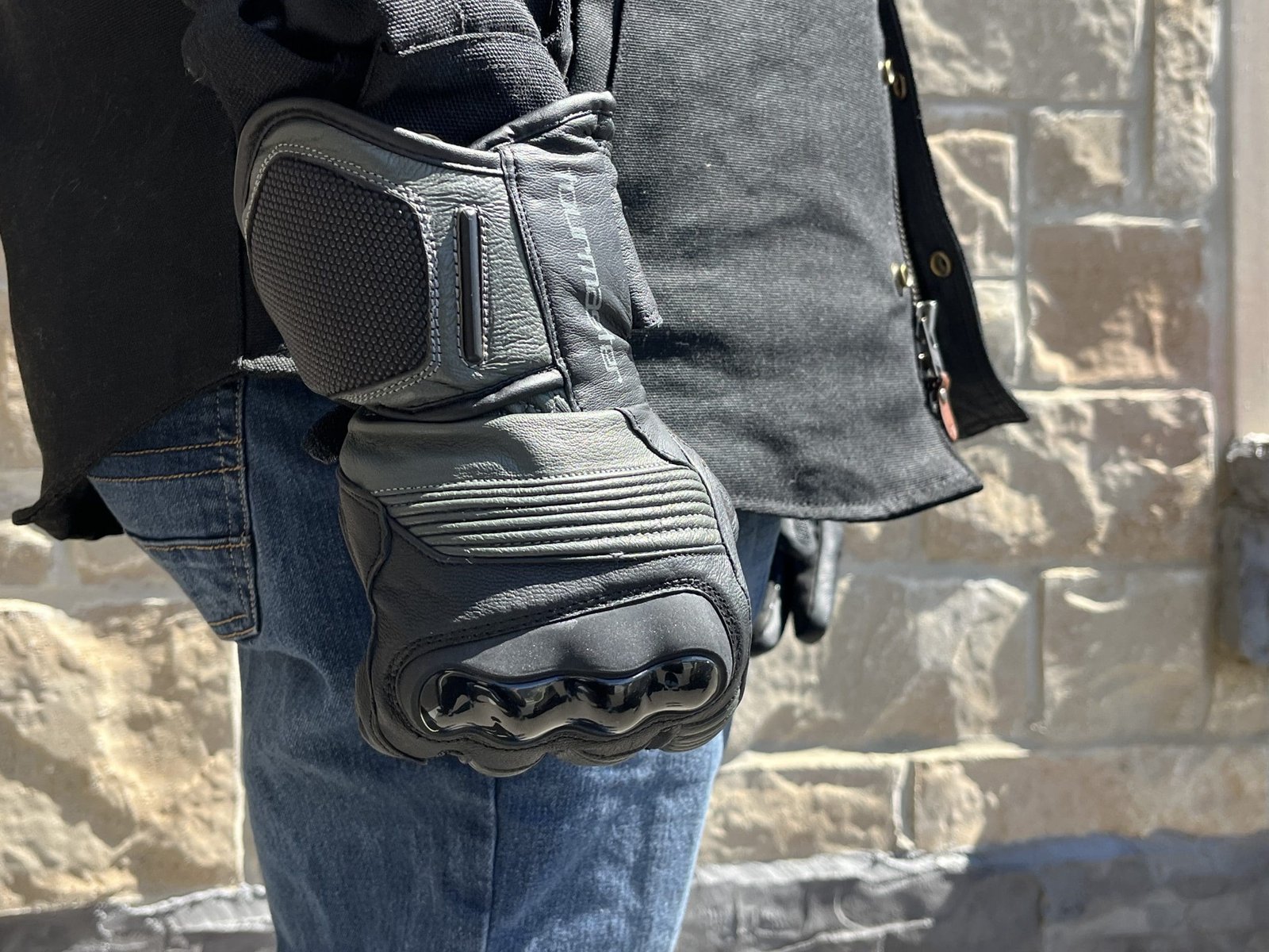 a motorcycle rider making a fist wearing the TOURMASTER Super Warm Waterproof Gloves