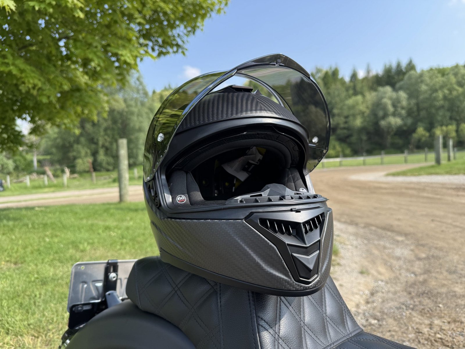 Close up photo of the Voss 991 Carbon helmet resting on a Harley Davidson seat