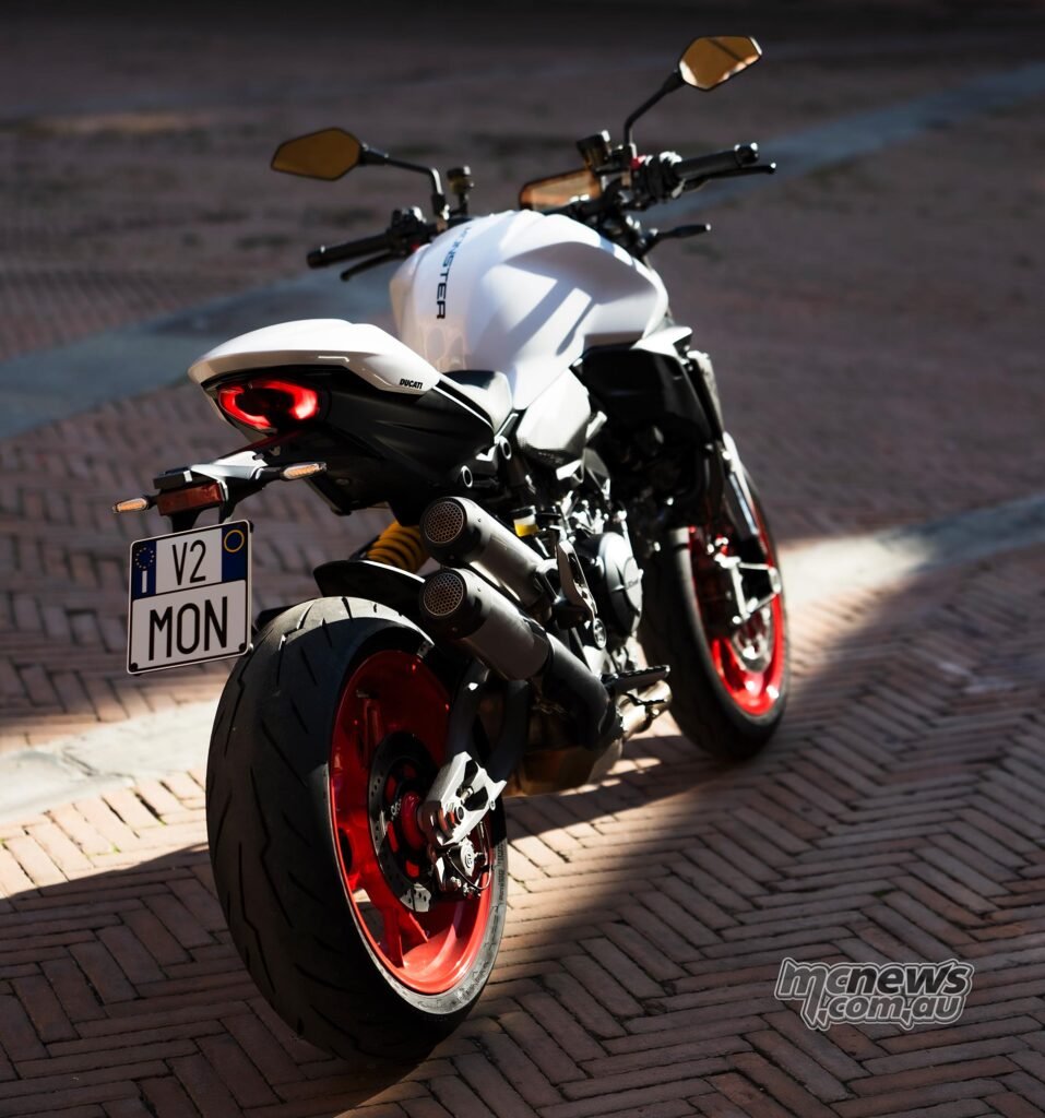 Rear three-quarter view of the 2026 Ducati Monster highlighting the short tail section and double-sided swingarm