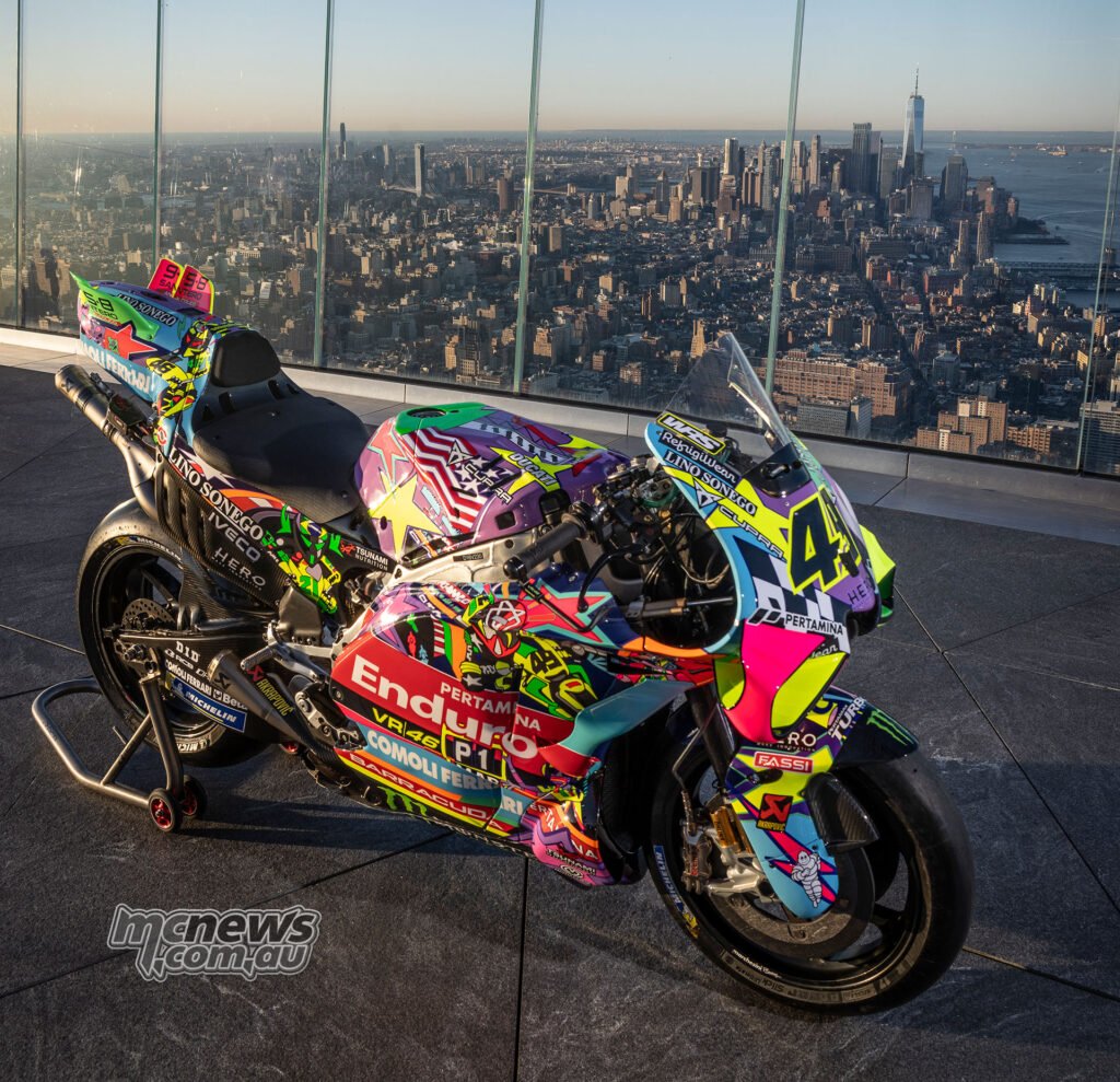 Side view of the VR46 Ducati MotoGP bike in special COTA livery with New York skyline in the background.