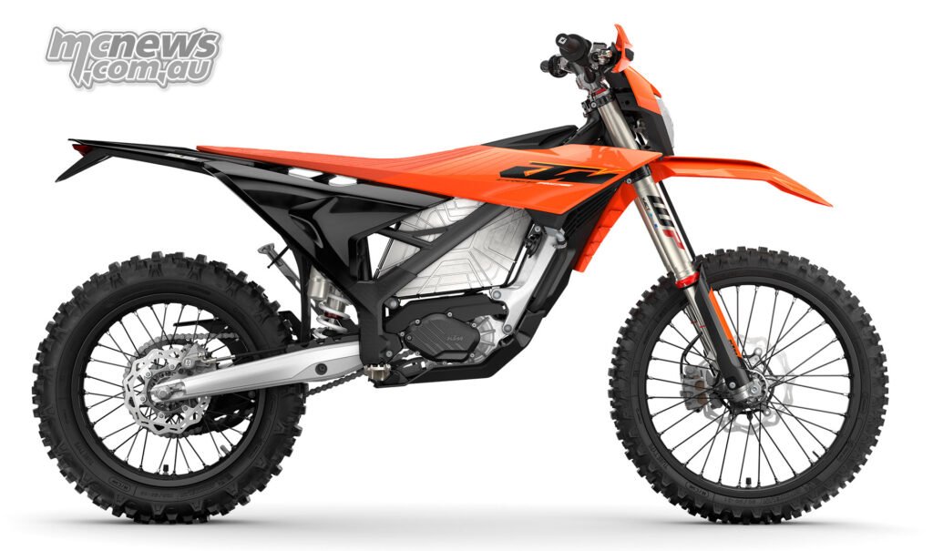 Studio right-side profile of the 2027 KTM Freeride E with orange bodywork and knobby tyres.