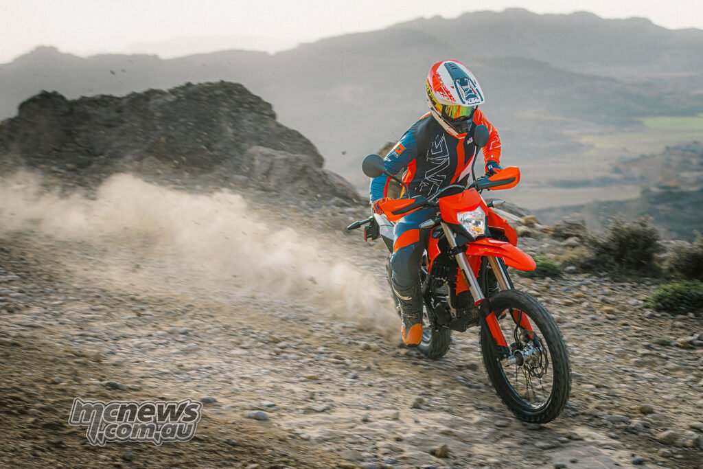Rider on the 2027 KTM Freeride E kicking up dust on a rocky hillside trail.