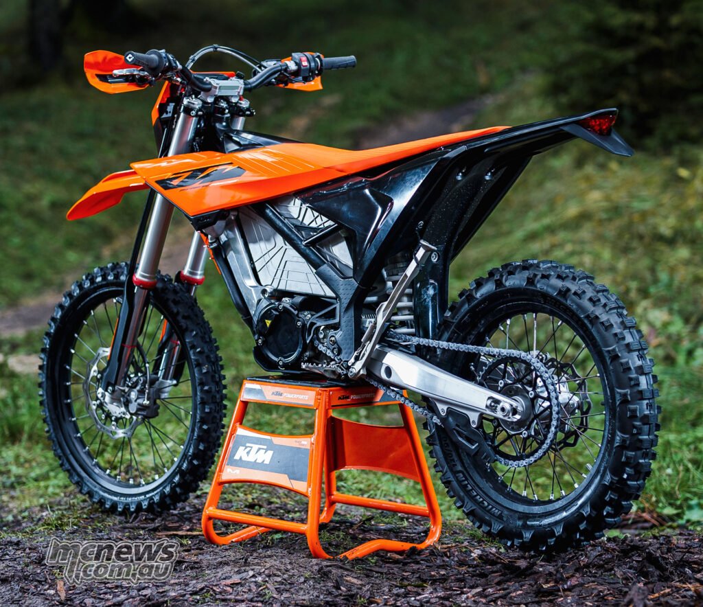 Rear three-quarter view of the 2027 KTM Freeride E showing the rear wheel, chain and tail section.